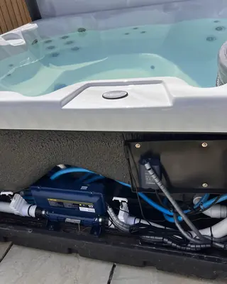 Inside a hot tub equipment bay: pumps, heater and control pack