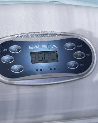 Balboa topside control panel set into the edge of a hot tub, showing the water temperature