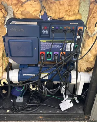 Gecko control pack inside a hot tub cabinet, with its wiring connected