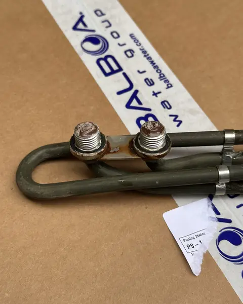 Hot tub heater element resting on the box from its replacement part