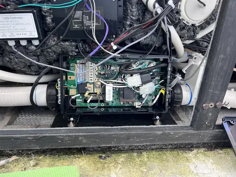 Hot tub control board and wiring inside an opened equipment bay