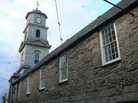 Penryn Town Hall, a granite building with a white clock tower and cupola